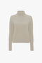 A Victoria Beckham Polo Neck Jumper In Ivory displayed on a white background.