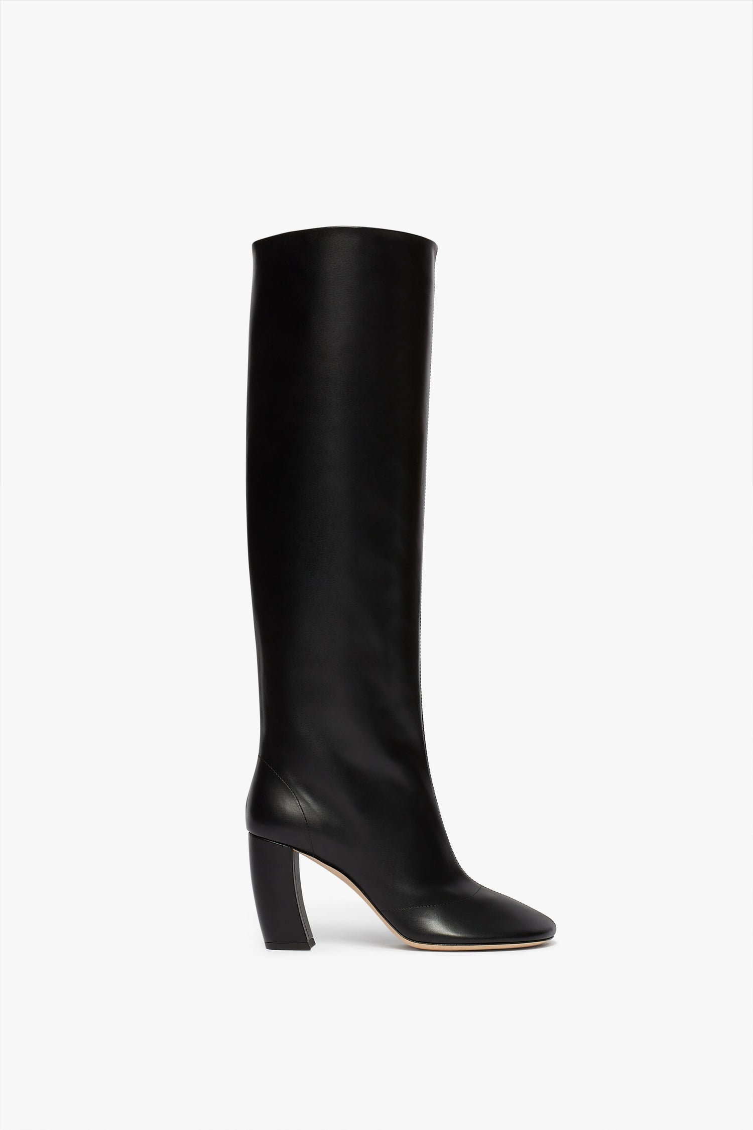 A single **Capri Rise Boot 115mm in Black**, by **Victoria Beckham**, in black calf leather, featuring a knee-high design with a rounded toe and an angular 115mm heel, isolated on a white background.