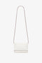 A minimalist white crossbody bag with a long, thin strap and a small rectangular body. The edges of the Victoria Beckham-inspired bag have subtle dark piping. The Mini Chain Pouch Bag With Long Strap In White Leather by Victoria Beckham comes with a removable strap for versatile styling options against the plain white background.