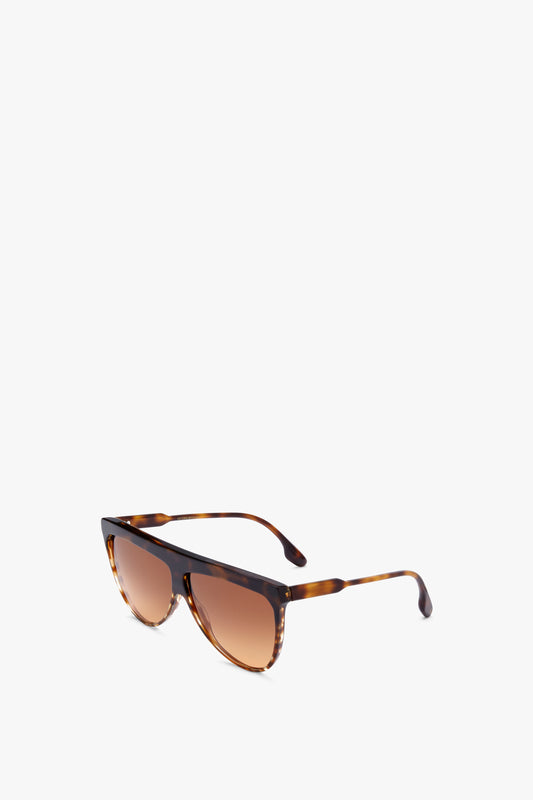 Flat Top V Sunglasses In Striped Dark Havana by Victoria Beckham with gradient lenses and acetate temples, made in Italy, against a plain white background.