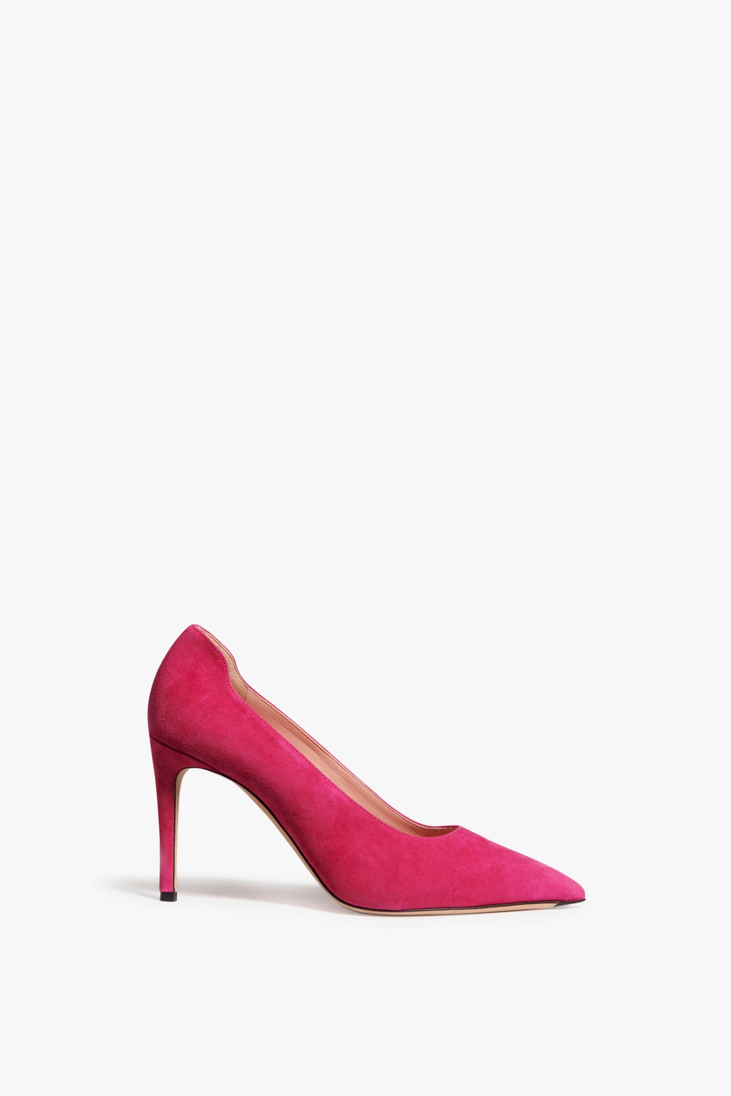 The VB Pump 90 in fuchsia pink suede is finished with a sharp, versatile, thin heel and pointed toe design. An iconic, classic style from Victoria Beckham Footwear.