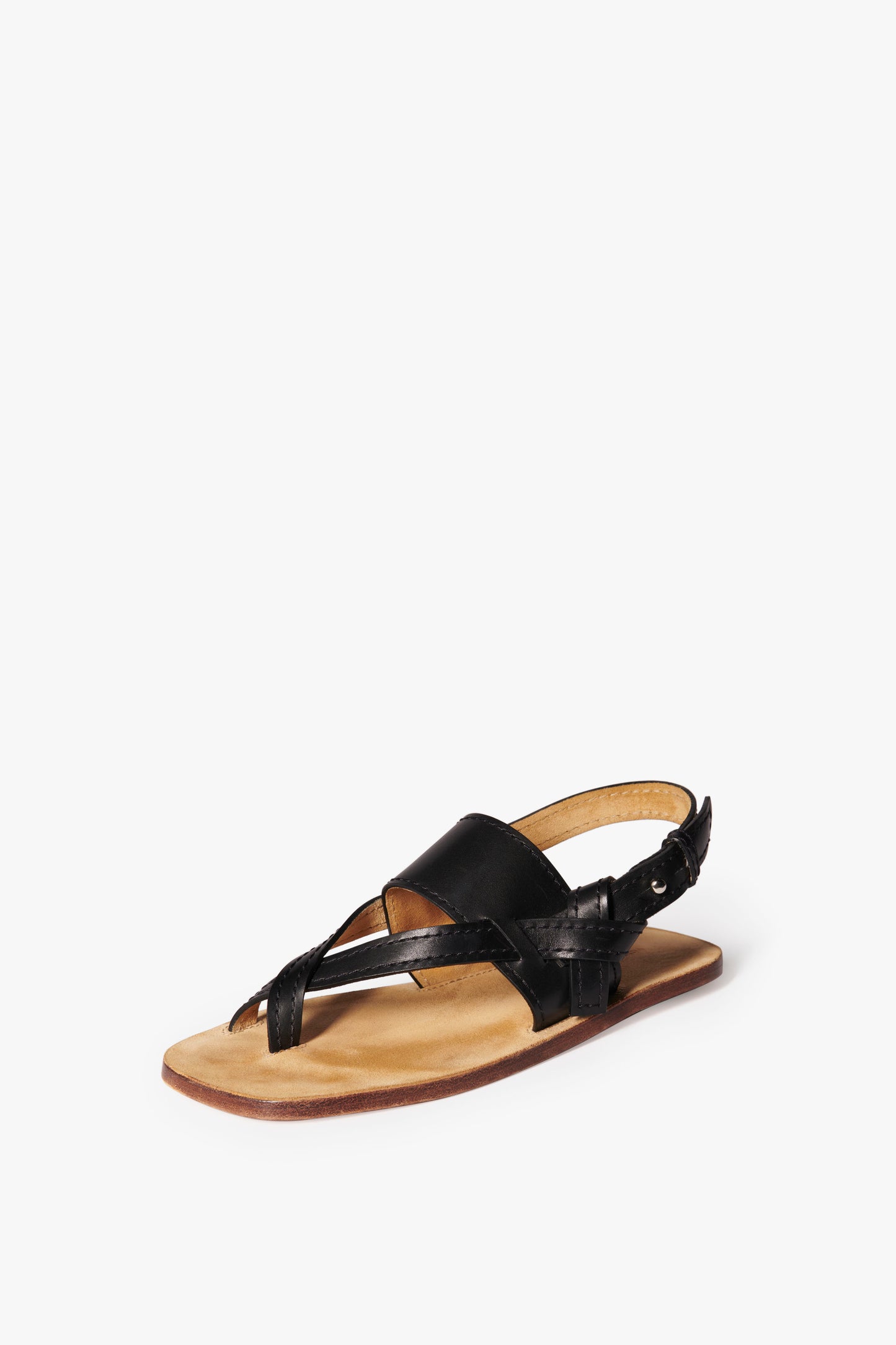 A single Eve Flat Sandal in Black by Victoria Beckham with crisscross straps and a flat tan sole is shown on a plain white background.