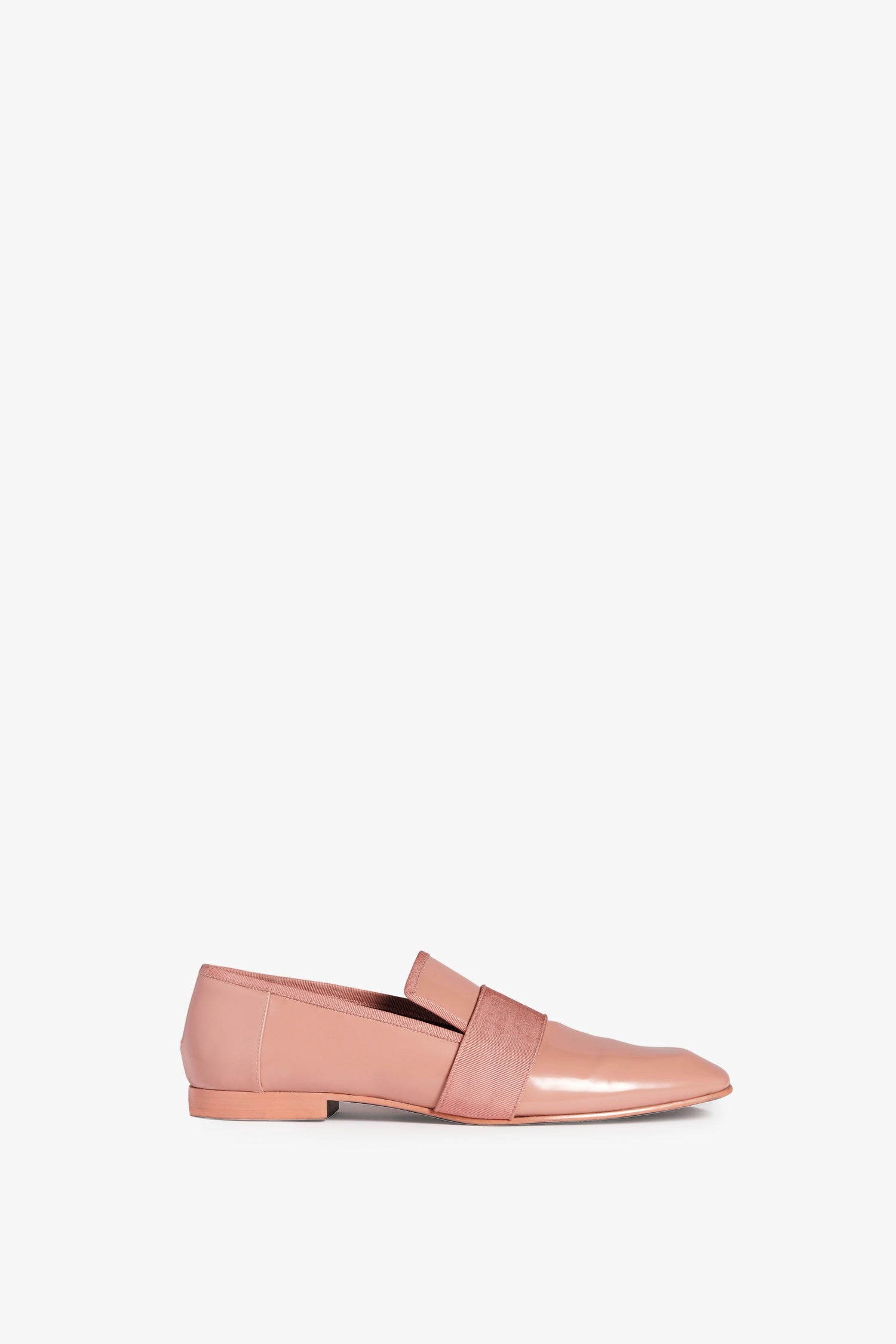 A side view of the Debbie Loafer in Rose by Victoria Beckham, showcasing a square-toe design and a low heel, with a wide elastic band across the instep.
