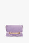 A Chain Pouch Bag with Strap in Lilac Suede from Victoria Beckham, crafted from luxurious Italian leather, featuring a matching detachable shoulder strap.