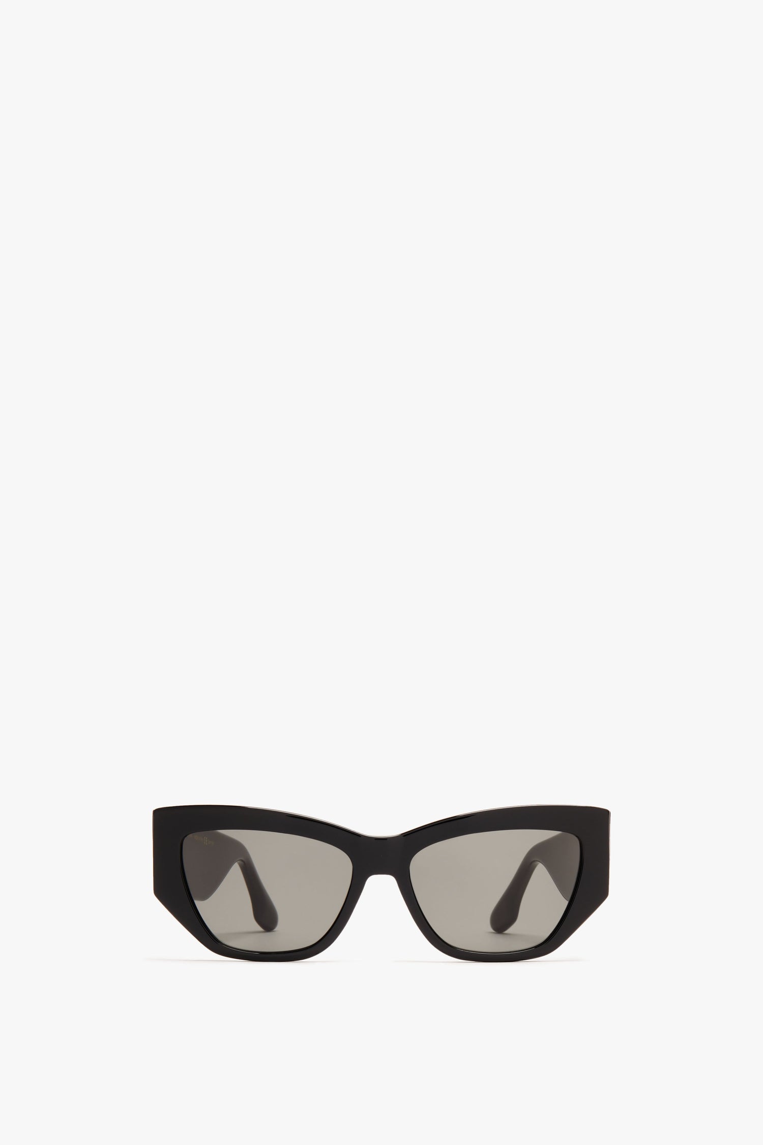 Victoria Beckham Sculptural Frame Sunglasses In Black with dark lenses on a white background.