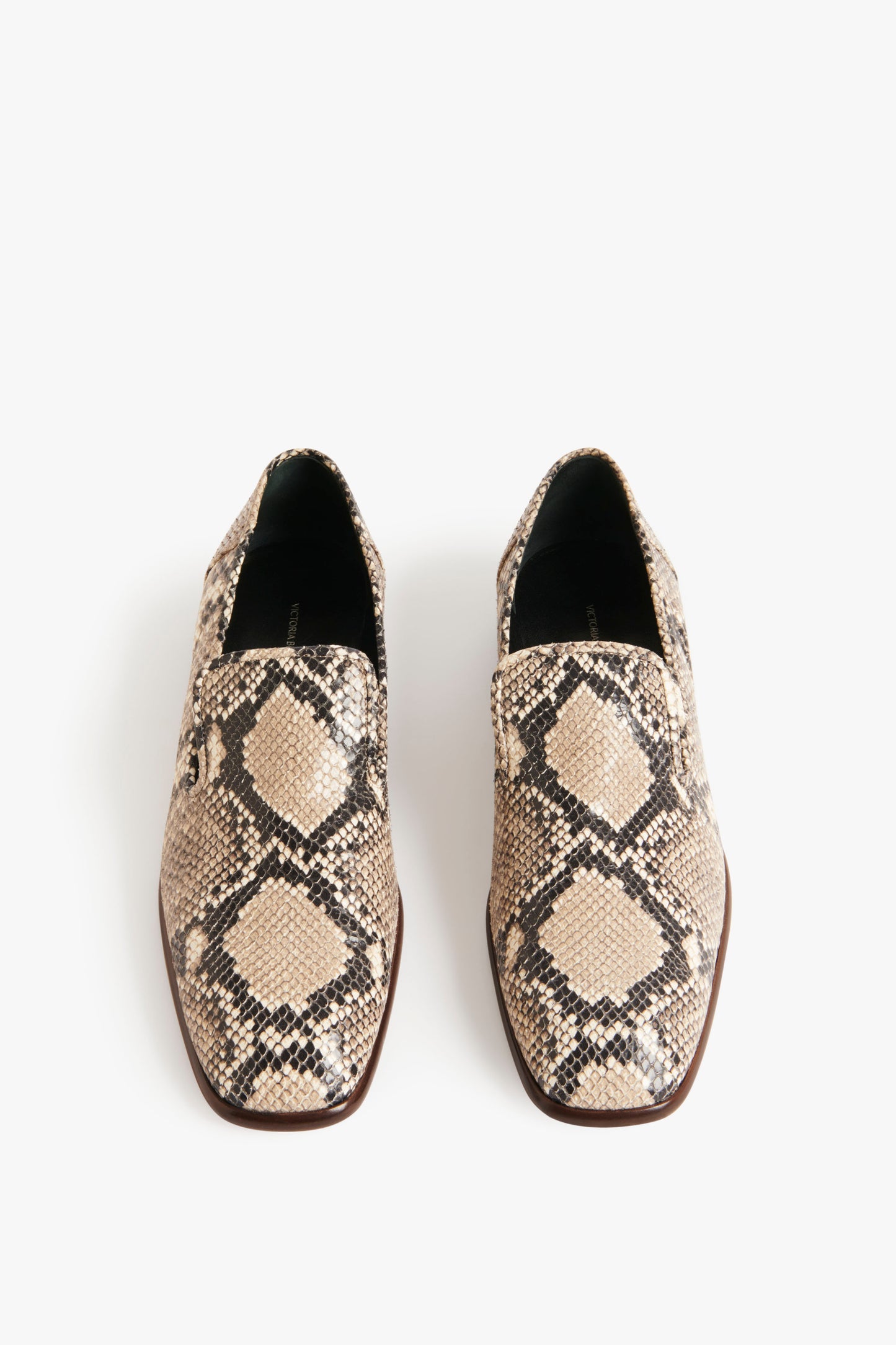 A pair of Victoria Beckham Hanna Loafer in Beige Snake Print slip-on shoes with a Beige Snake Print leather finish and geometric pattern, featuring black, beige, and brown tones, displayed against a white background.