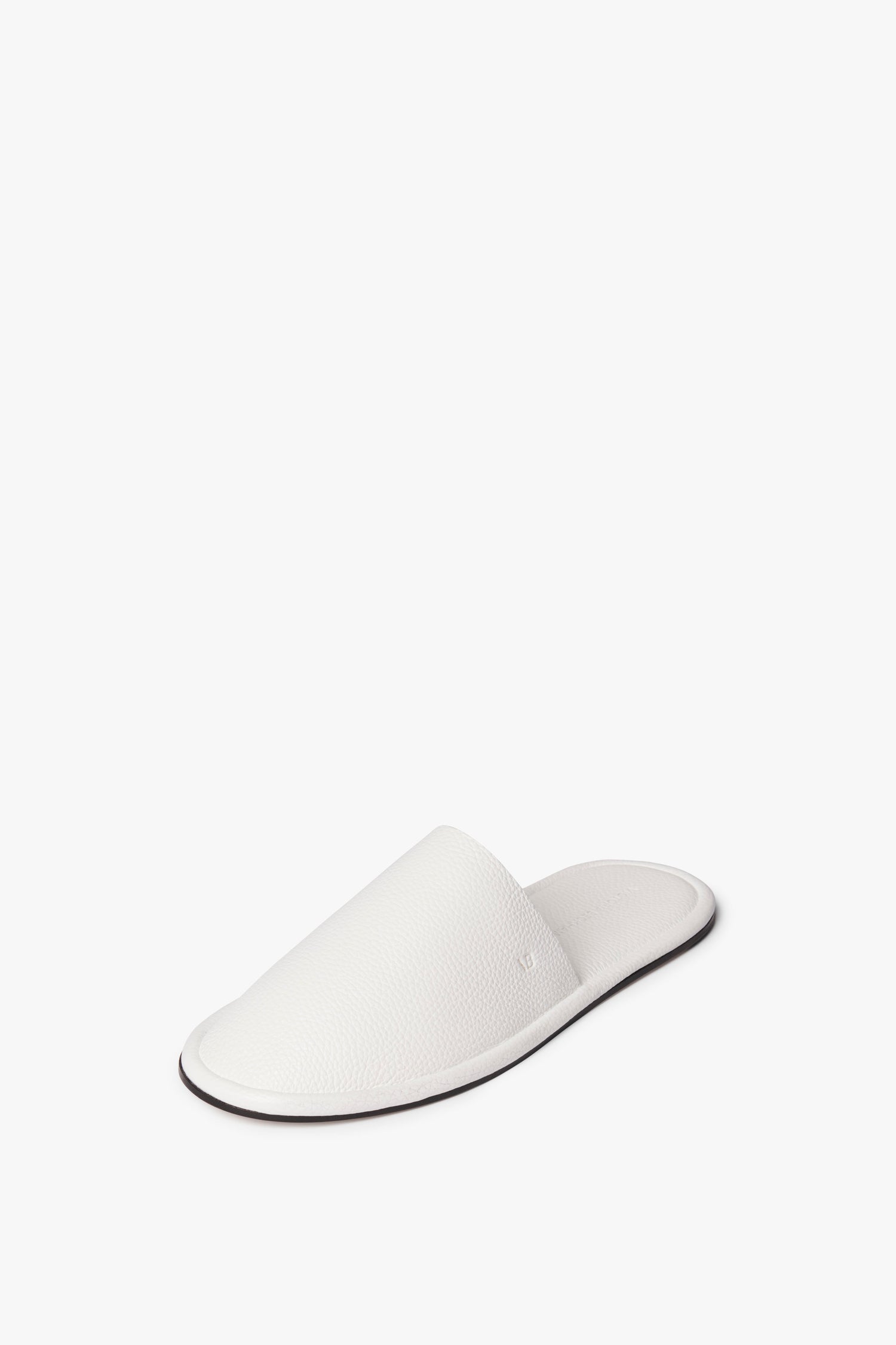 A single white Amelia Leather Mule in White by Victoria Beckham with an open-back design and a flat black sole, crafted from embossed leather, displayed on a white background.