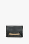 Chain Pouch Bag In Black Leather Victoria Beckham clutch with gold-tone hardware, isolated on a white background.