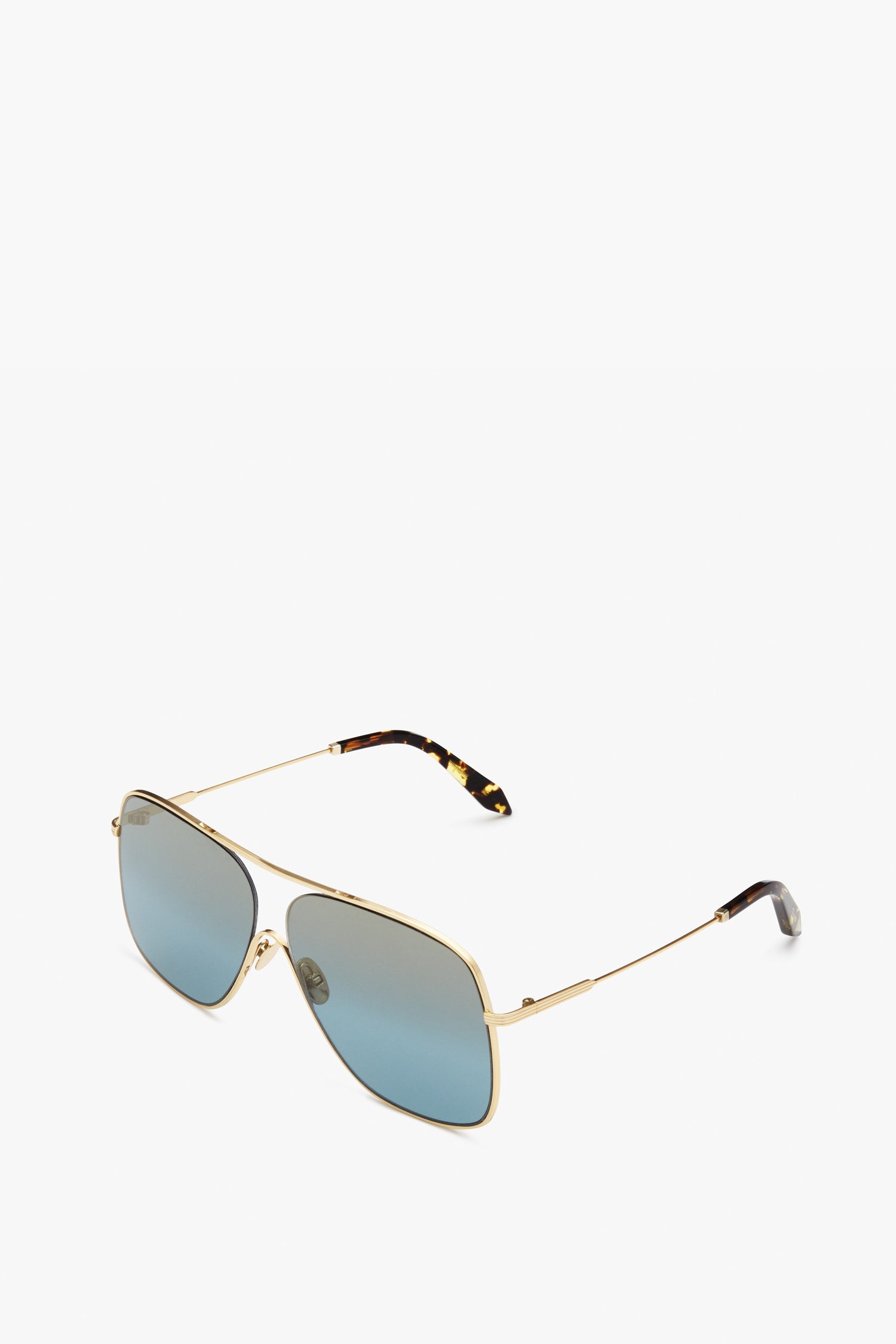 Loop Navigator in Celeste by Victoria Beckham with gold frames, light blue rectangular lenses, and thin arms featuring a tortoiseshell pattern on the tips, made in Italy, set on a white background.