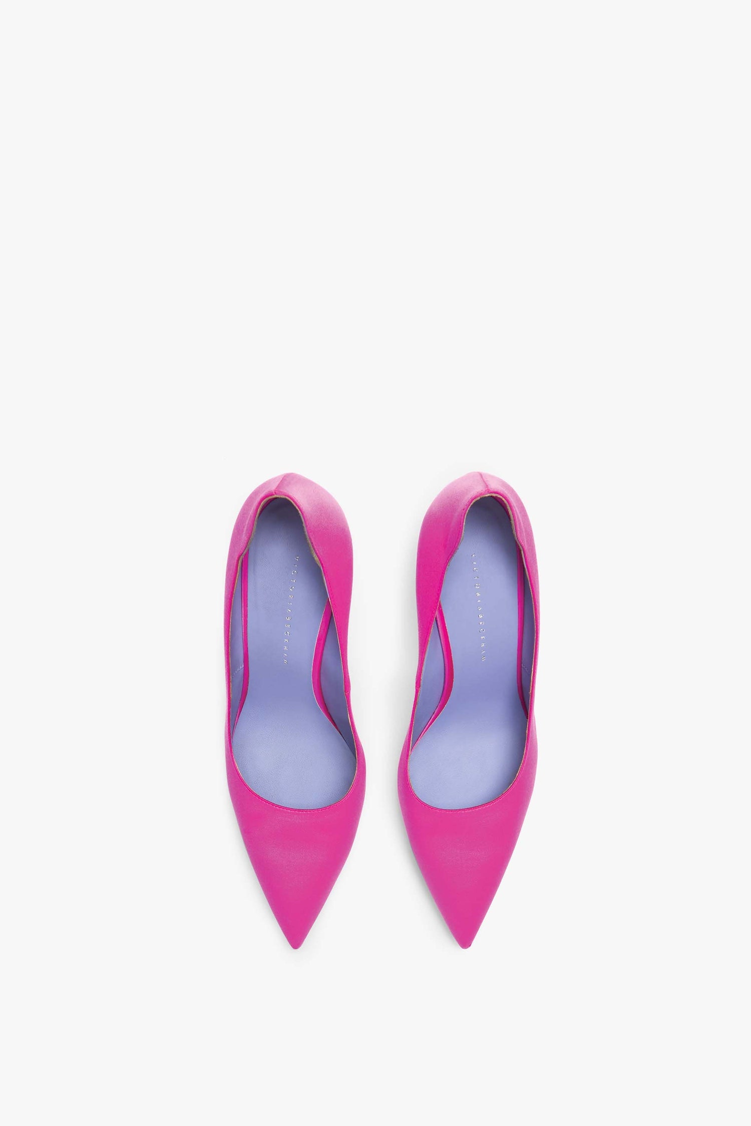 A pair of vibrant pink high-heeled shoes with purple insoles, handcrafted in Italy and featuring a sleek 90mm stiletto heel, viewed from above. Introducing the VB 90 Pumps by Victoria Beckham.